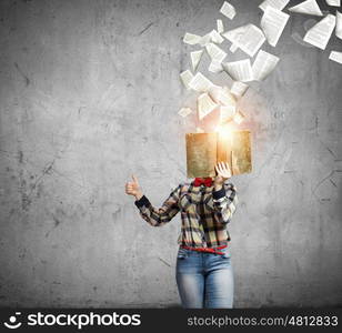 Reading concept. Woman in casual wear hiding her face behind book