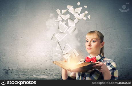 Reading concept. Woman in casual wear holding opened book in hands