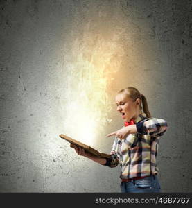 Reading concept. Woman in casual wear holding opened book in hands