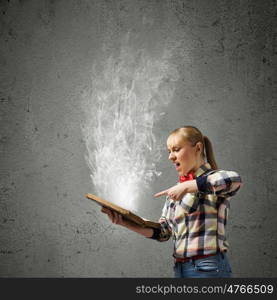 Reading concept. Woman in casual wear holding opened book in hands