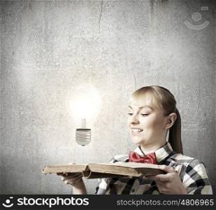 Reading concept. Woman in casual wear holding opened book in hands