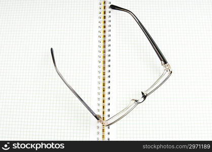 Reading glasses on the black page