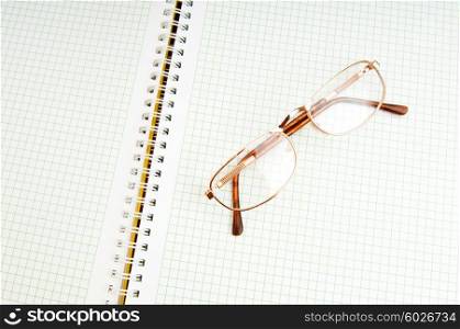 Reading glasses on the black page