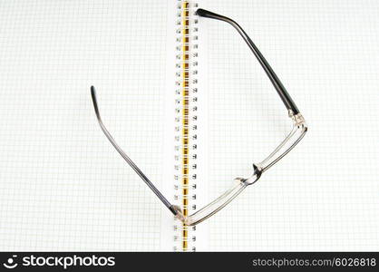 Reading glasses on the black page