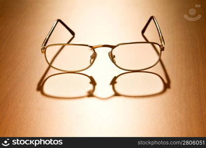 Reading glasses on the wooden table