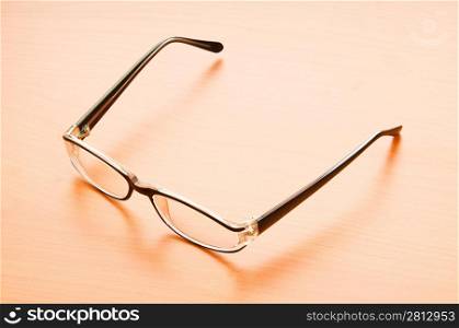 Reading glasses on the wooden table