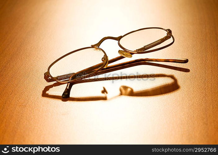 Reading glasses on the wooden table