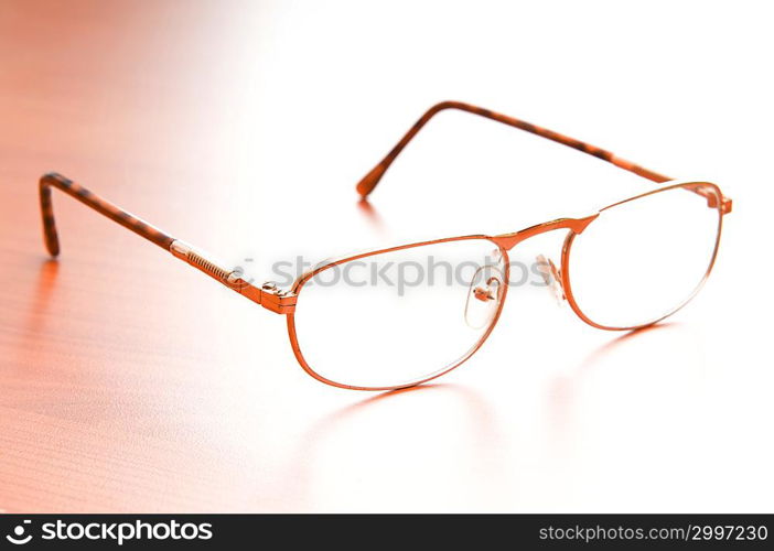 Reading glasses on the wooden table