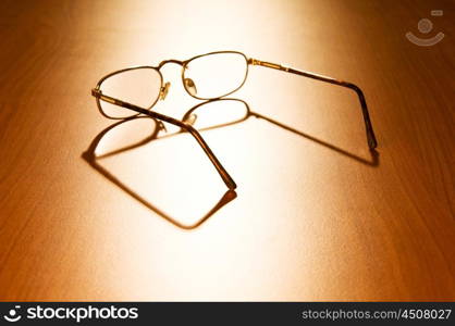 Reading glasses on the wooden table