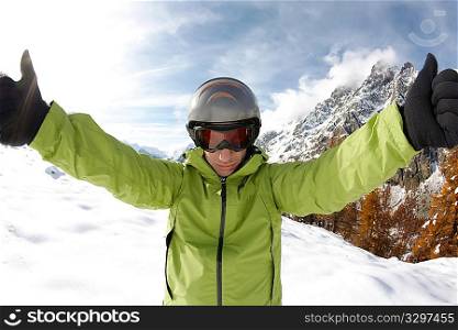 Ready for skiing. Portrait of young caucasian skier, on background a winter alpine landscape.