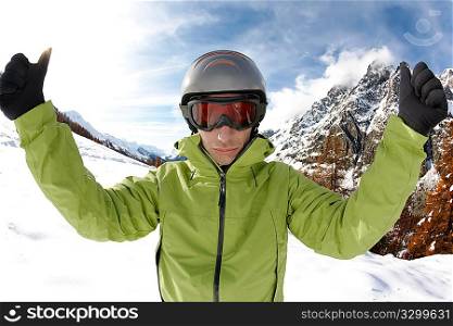 Ready for skiing. Portrait of young caucasian skier, on background a winter alpine landscape.