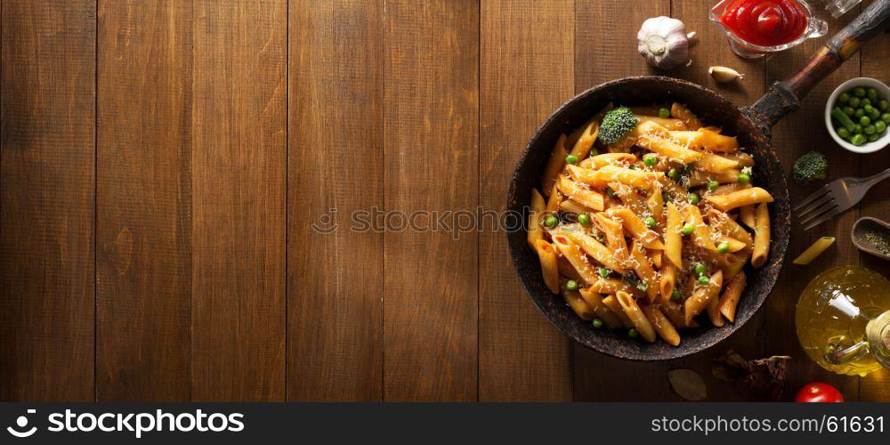 ready pasta on wooden background