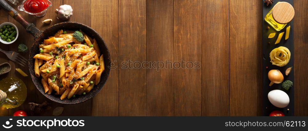 ready pasta on wooden background