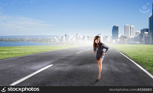 Ready to run. Young determined businesswoman standing in start position