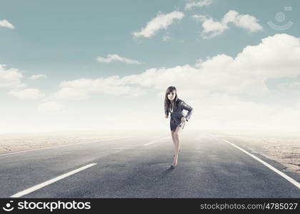 Ready to run. Young determined businesswoman standing in start position