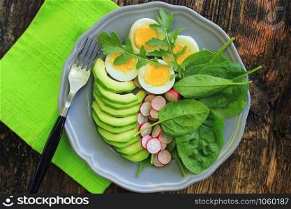 reakfast salad with radishes, boiled egg and mix lettuce leaves,spinach. Food background. Top view .. Breakfast salad with radishes, boiled egg and mix lettuce leaves,spinach. Food background. Top view