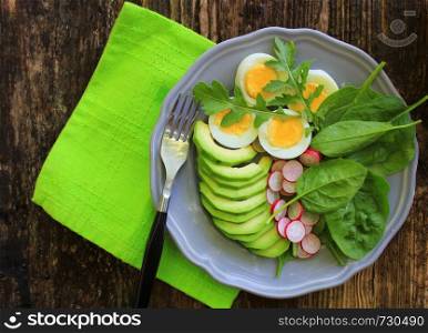 reakfast salad with radishes, boiled egg and mix lettuce leaves,spinach. Food background. Top view .. Breakfast salad with radishes, boiled egg and mix lettuce leaves,spinach. Food background. Top view