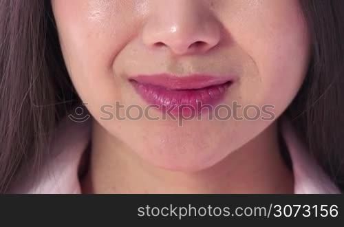 Real Asian people portrait with emotions and feelings. Close-up of face. Beautiful young Japanese woman, lady, pretty girl kissing, blowing sexy kiss. Detail of sensual mouth and lips. Love, romance