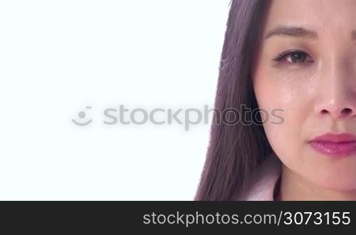 Real Asian people portrait with emotions and feelings. Close-up of face on white background. Beautiful young depressed Japanese woman, sad lady, anxious pretty girl looking at camera. Sadness, anxiety