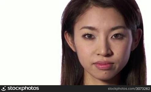 Real Asian people portrait with emotions and feelings. Close-up of face on white background. Beautiful young depressed Japanese woman, sad lady, anxious pretty girl looking at camera. Sadness, anxiety