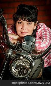 Real biker girl sits on a motorcycle