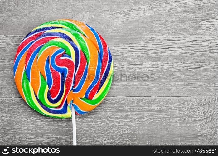 Real Colorful spiral lollipop on wooden vintage table