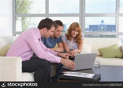 Real Estate Agent and Couple in Meeting