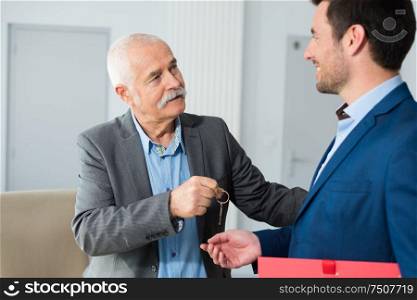 real estate agent giving keys to property owner
