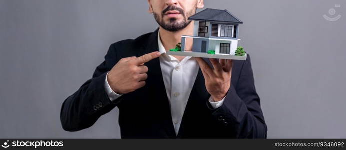 Real estate agent hold house model s&le on isolated background. Housing business showcase with copy space. Realtor presenting property investment opportunity on house loan idea. Fervent. Real estate agent hold house model s&le on isolated background. Fervent