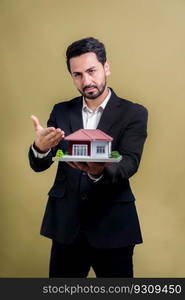 Real estate agent hold house model sample on isolated background. Housing business showcase with copy space. Realtor presenting property investment opportunity on house loan idea. Fervent. Real estate agent hold house model sample on isolated background. Fervent