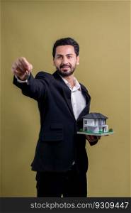 Real estate agent hold house model sample with a key on isolated background. Housing business with copyspace. Realtor presenting key property investment opportunity on house loan idea. Fervent. Real estate agent hold house model and key on isolated background. Fervent