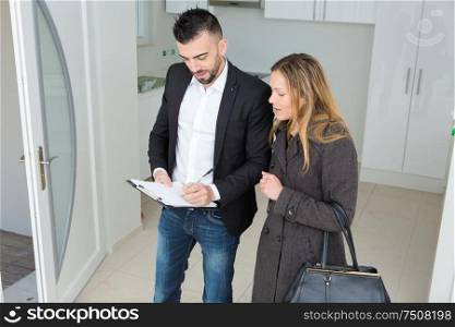 real estate agent showing apartment to young woman