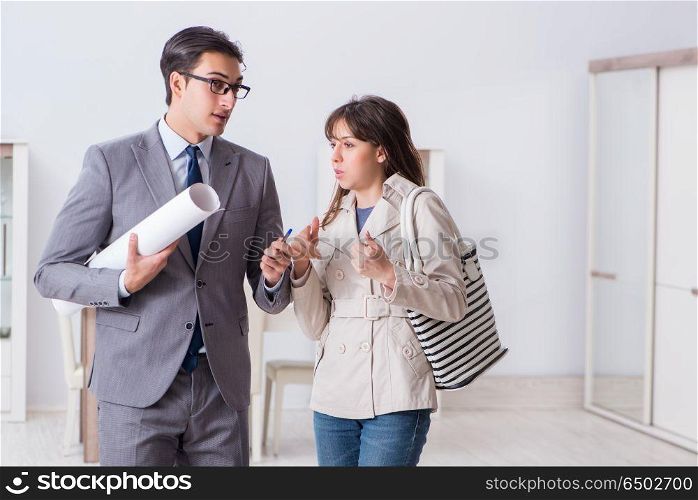 Real estate agent showing new apartment property to client