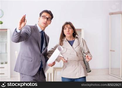 Real estate agent showing new apartment property to client