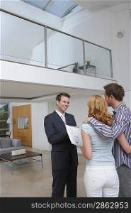 Real Estate Agent with Clients in New Home