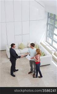 Real Estate Agent With Couple Buying New Apartment
