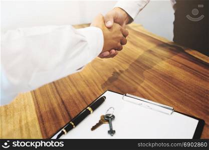 Real Estate agent with customer making contract deal signature and analyzing valuation