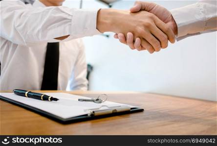 Real Estate agent with customer making contract deal signature and analyzing valuation