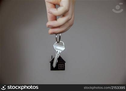 Real estate agent with house model and keys, selling house,property owner mortgage concept with copy space on gray background space for text. Real estate agent with house model and keys, selling house,property owner mortgage concept with copy space on gray background