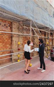 real estate agents checking construction works