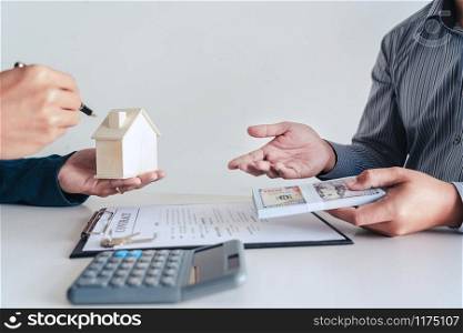 Real estate agents explain the document for customers who come to contact to buy a house, buy or sell real estate concept