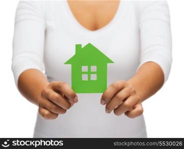 real estate and eco concept - closeup picture of woman hands holding green house