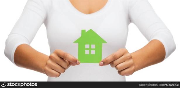 real estate and eco concept - closeup picture of woman hands holding green house. woman hands holding green house