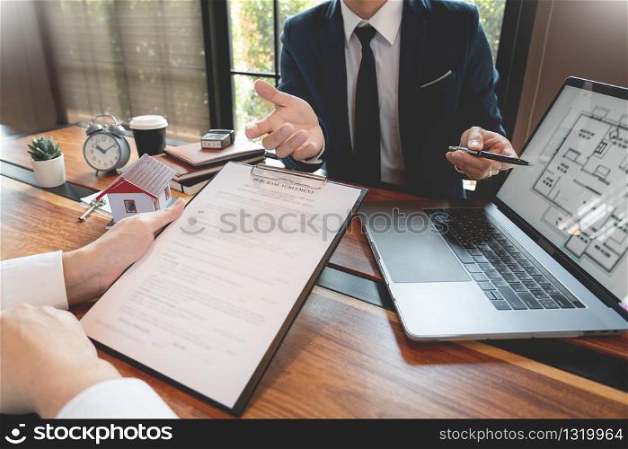 Real Estate broker or sale agent giving consultation to customer about buying house sign agreement document contract. Home loan concept
