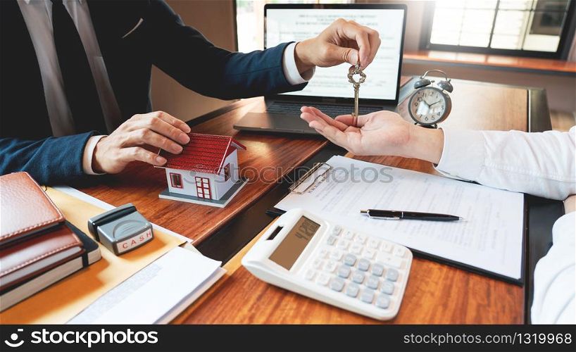 Real Estate broker or sale agent giving consultation to customer about buying house sign agreement document contract. Home loan concept