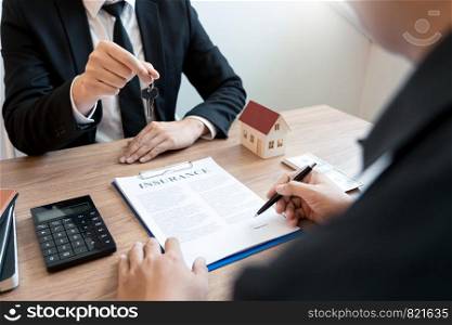 Real Estate broker or sale agent giving consultation to customer about buying house sign agreement document contract. Home loan