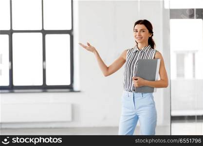 real estate business and people concept - businesswoman or realtor with folder at office. businesswoman or realtor with folder at office. businesswoman or realtor with folder at office