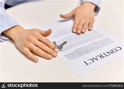 real estate business and people concept - close up of businesswoman or realtor&rsquo;s hands with keys and contract on table. realtor&rsquo;s hands with keys and contract on table