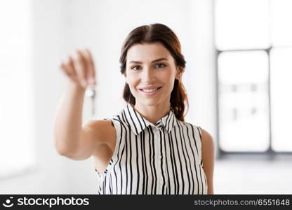 real estate business and people concept - woman realtor with key at office. woman realtor with key at office. woman realtor with key at office