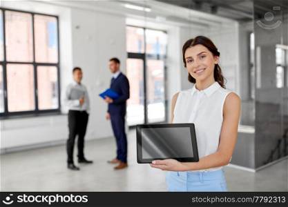 real estate business, sale and people concept - happy smiling realtor or businesswoman showing tablet pc computer screen and customers at new office room. realtor showing tablet pc and customers at office
